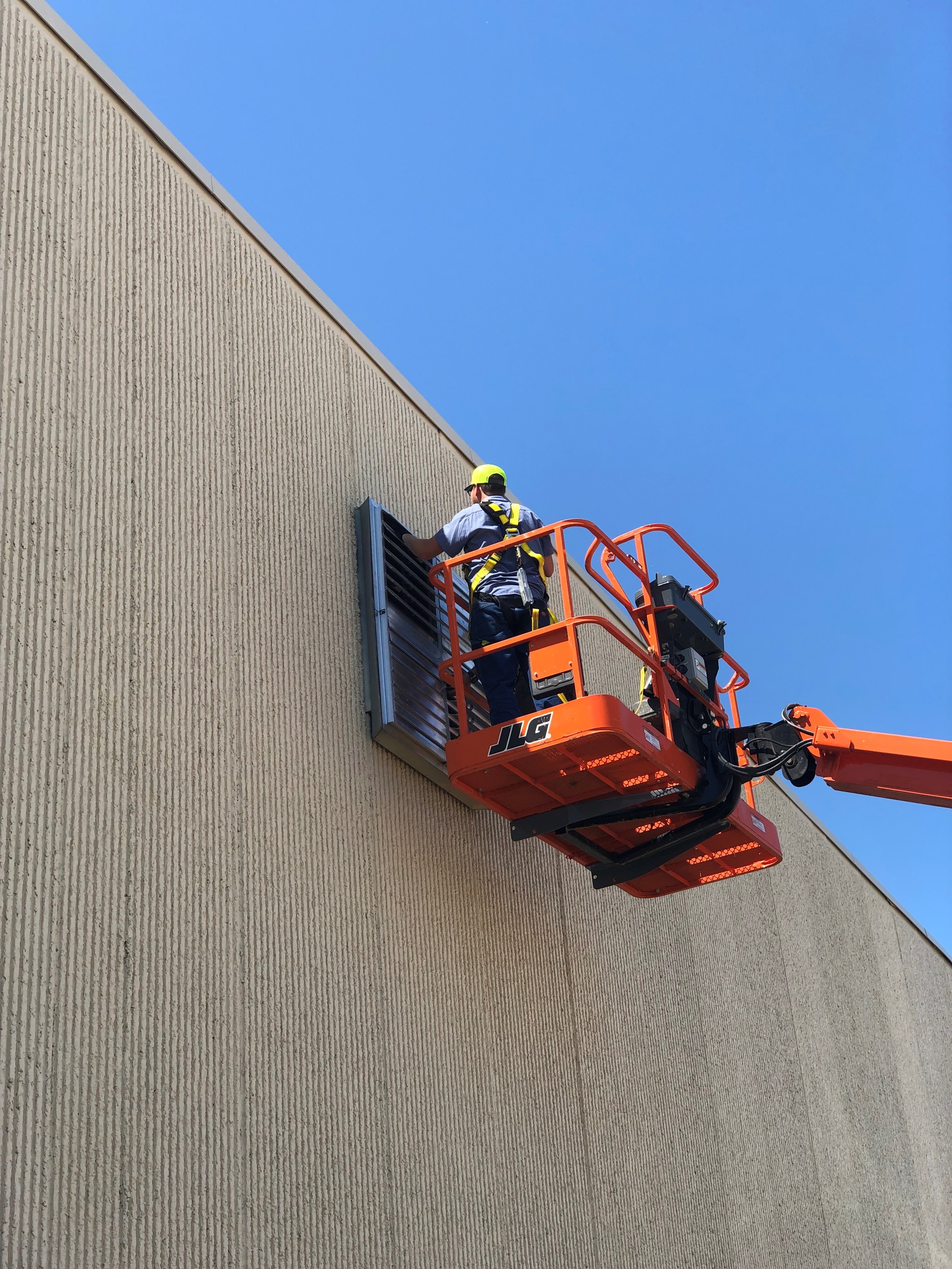 Worker fixing commercial system.
